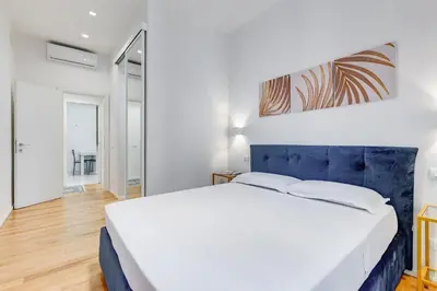 a white bedroom with a large bed in a room at Opera Exclusive House by Premium Suites Collection in Rome
