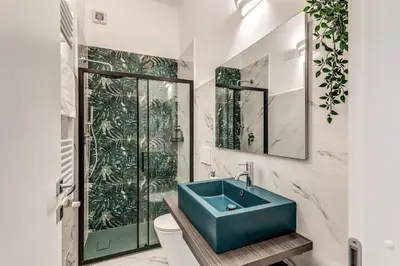 a bathroom with a blue sink and a shower at Nala Luxury Apartment with terrace in Rome