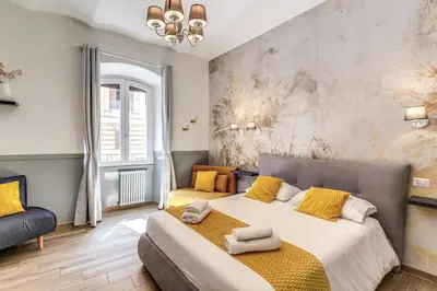a bedroom with a large bed with yellow pillows at Nala Luxury Apartment with terrace in Rome