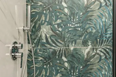 a bathroom with a shower with a green leaf wallpaper at Nala Luxury Apartment with terrace in Rome