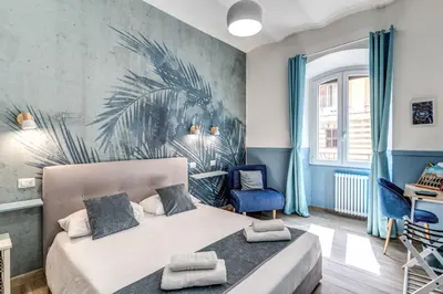 a patio with a table and chairs and an umbrella at Nala Luxury Apartment with terrace in Rome