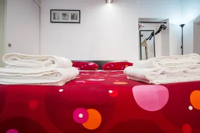 a room with a red bed with towels on it at Apartment Gaia in Rome