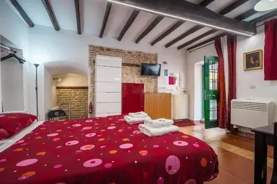 a bedroom with a red bed with polka dots at Apartment Gaia in Rome