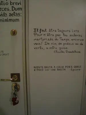 a door with a sign on it with writing on it at La Casa Dei Gerani in Rome