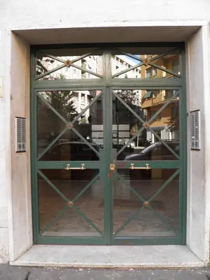 a green door on a building with a window at La Casa Dei Gerani in Rome