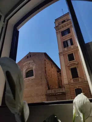 a view of a clock tower from a window at Holiday 168 Guest House in Rome