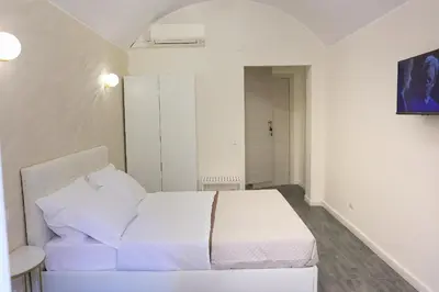 a bedroom with a white bed in a room at Holiday 168 Guest House in Rome