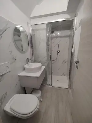 a bathroom with a toilet and a sink and a shower at Holiday 168 Guest House in Rome
