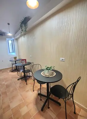 a row of tables and chairs in a room at Holiday 168 Guest House in Rome