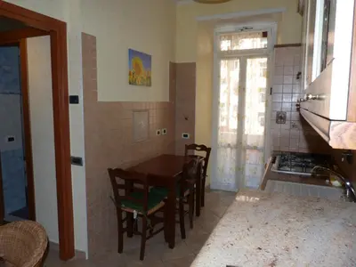 a kitchen with a table and chairs in a room at Rossanella House in Rome