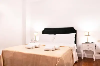 a bedroom with a large bed with two towels on it at Charme & Chic San Giacomo in Rome
