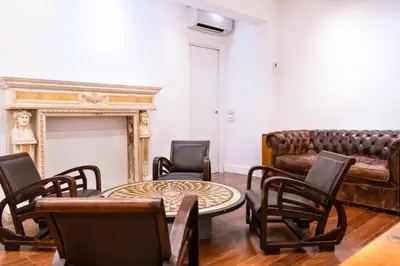 a living room with a couch and a table and chairs at Charme & Chic San Giacomo in Rome