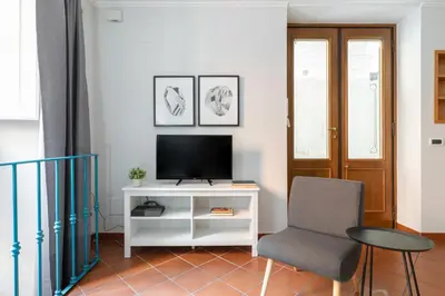 a white kitchen with white cabinets and a sink at Dolce Vita Dreaming Studio in Rome