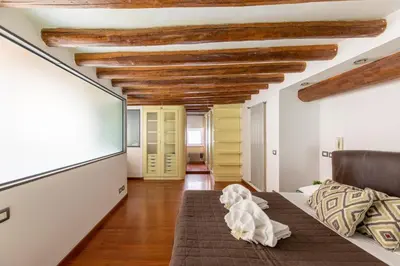 a living room with a dog sitting on a couch at Santa Cecilia Loft in Rome