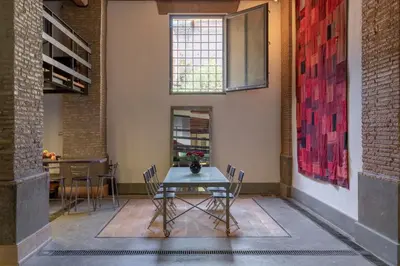 a dining room with a table and chairs at Santa Cecilia Loft in Rome