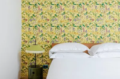 a bedroom with a bed with a floral wallpaper at TrastevereHome - Santa Maria della Quercia in Rome