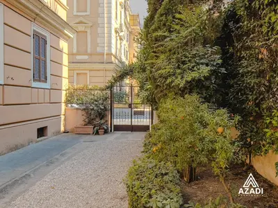 a building with a door and some plants and trees at Azadi Suite Flaminio in Rome