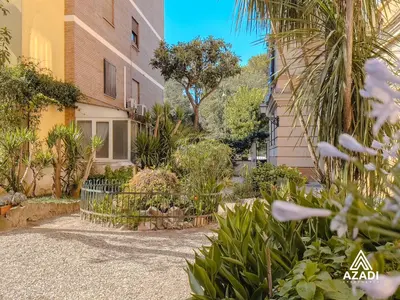 a courtyard of a building with plants and trees at Azadi Suite Flaminio in Rome