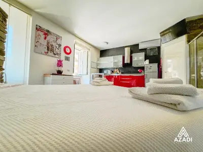 a bedroom with a large bed with towels on it at Azadi Suite Flaminio in Rome