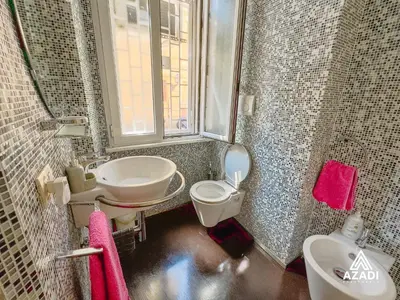 a bathroom with a sink and a toilet and a window at Azadi Suite Flaminio in Rome