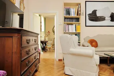 a living room with a dresser and a chair at On The Steps in Rome