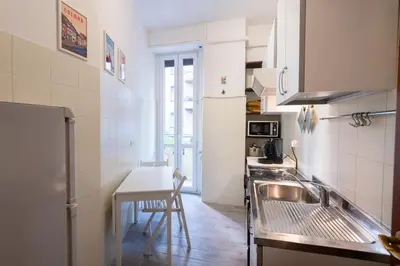 a small kitchen with a sink and a table at Casa Riboty in Rome