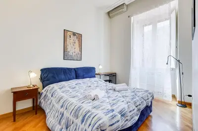 a bedroom with a blue bed with a stuffed animal on it at Crescenzio St Peter’s House in Rome