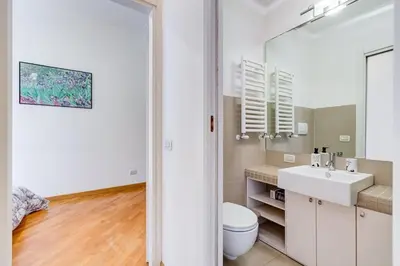 a white bathroom with a sink and a toilet at Crescenzio St Peter’s House in Rome