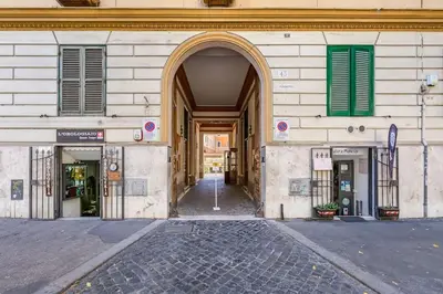 an entrance to a building with green windows and a street at Crescenzio St Peter’s House in Rome