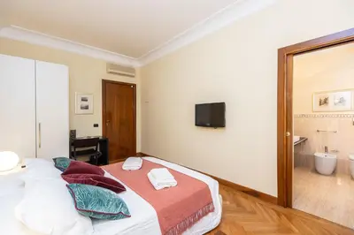 a bedroom with a bed and a tv on the wall at TimeRoma Vatican in Rome