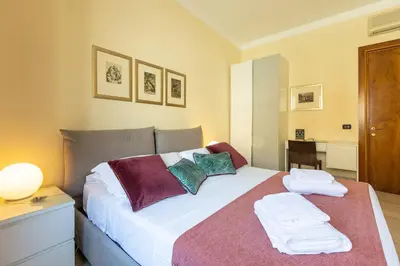 a bedroom with a bed with towels on it at TimeRoma Vatican in Rome