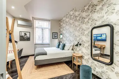 a bedroom with a bed and a mirror at Daag Corso Luxury Apartment in Rome