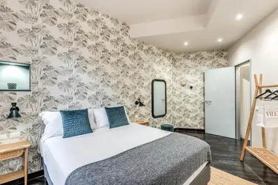 a bedroom with a bed and a wall with flowers at Daag Corso Luxury Apartment in Rome