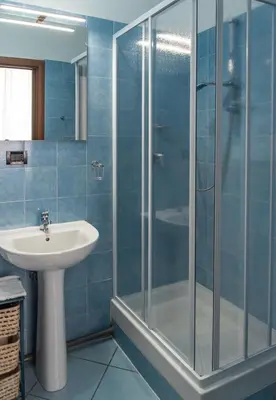 a bathroom with a glass shower and a sink at Pura Vida in Rome