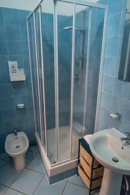 a bathroom with a shower and a toilet and a sink at Pura Vida in Rome