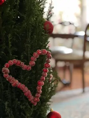 a christmas tree with a heart ornament on it at Casa Fiore in Rome