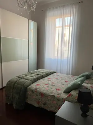 a bedroom with a bed and a large window at Casa Fiore in Rome