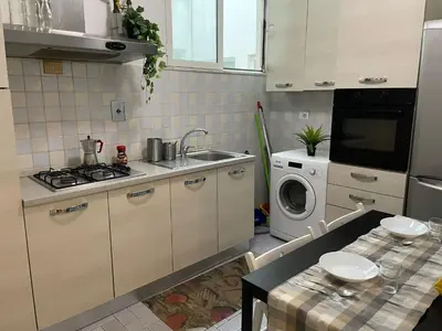 a kitchen with a sink and a washing machine at Group Apartment Roma in Rome
