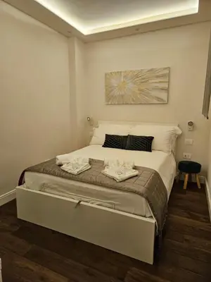 a bedroom with a large bed with two towels on it at THE ONE FRATTINA Apartment in Rome