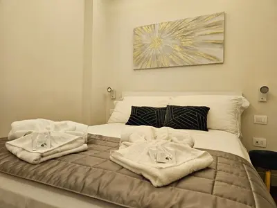 a bedroom with a bed with towels on it at THE ONE FRATTINA Apartment in Rome