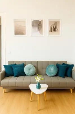 a living room with a couch with blue pillows and a table at Flaminio Luxury - GR HOME in Rome