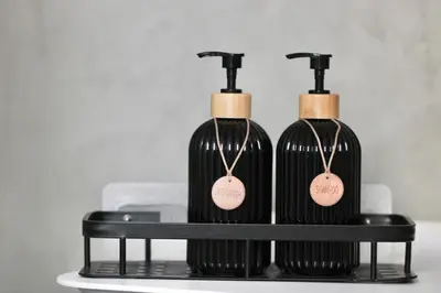 two black bottles of wine sitting on a shelf at Flaminio Luxury - GR HOME in Rome