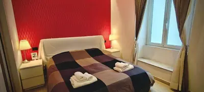 a bedroom with a bed with two towels on it at ROMAnce Cosimato Trastevere B&B in Rome