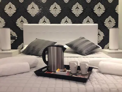 a tray with a coffee pot on top of a bed at ROMAnce Cosimato Trastevere B&B in Rome
