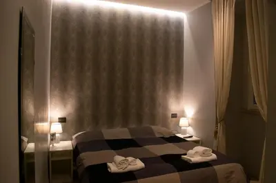 a hotel room with a bed with towels on it at ROMAnce Cosimato Trastevere B&B in Rome