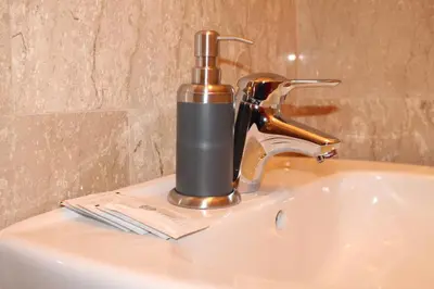 a bathroom sink with a faucet on a sink at Roma Art Rooms in Rome