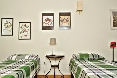 two beds sitting next to each other in a room at Minerva House in Rome