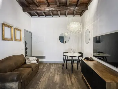 a living room with a couch and a table at DomusLu' - Casa di charme nel cuore di Roma in Rome