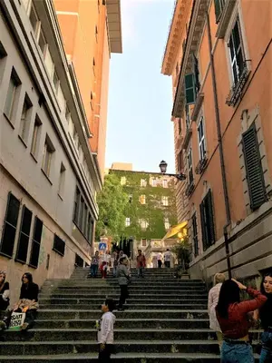 a group of people walking down stairs in an alley at Nest to Colosseum in Rome