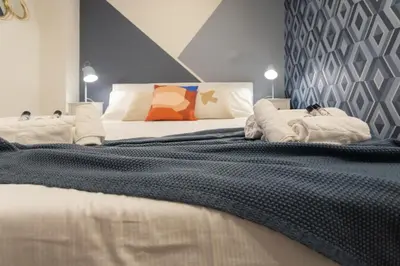a bedroom with a large bed with towels on it at Nina - Tiny Suite in Trastevere in Rome